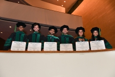 Showing off their degrees!